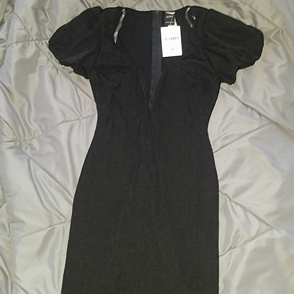 Black dress with deep V neckline.